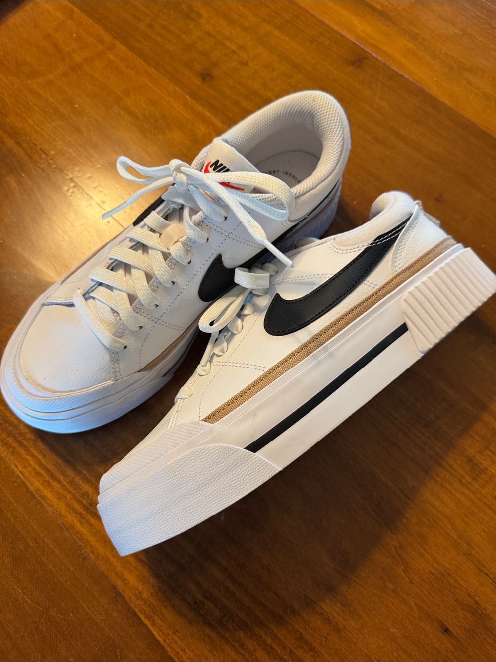 Nike Women’s White Sneakers with Black Swoosh and Tan Stripe